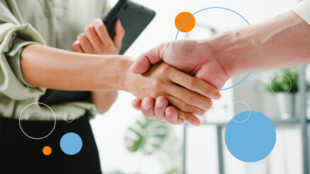 Two people shaking hands as a way of closing the deal, having reached a translation services for business agreement.