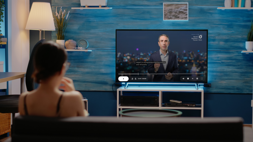 Girl watching multimedia content with  sutitles on.